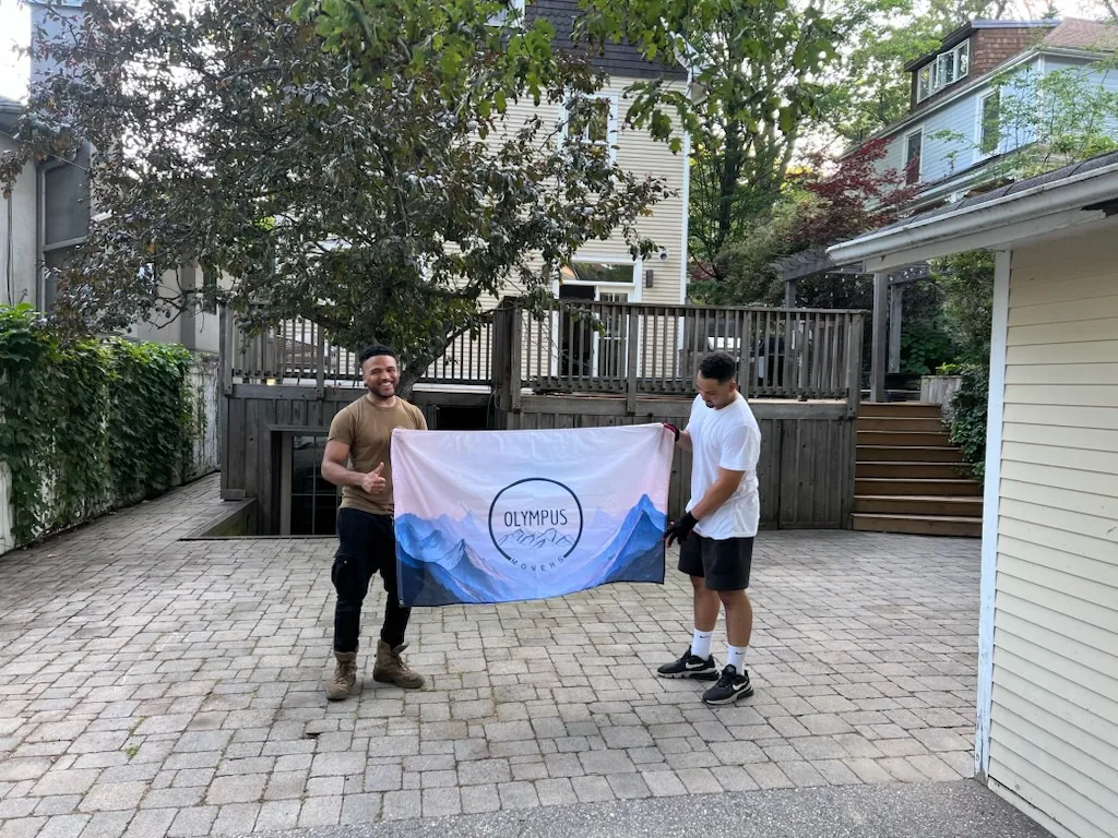 Olympus movers logo on a mountain range background